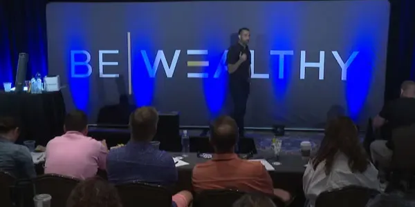 Ali Nasser speaking to a room of advisors at a WISE bootcamp